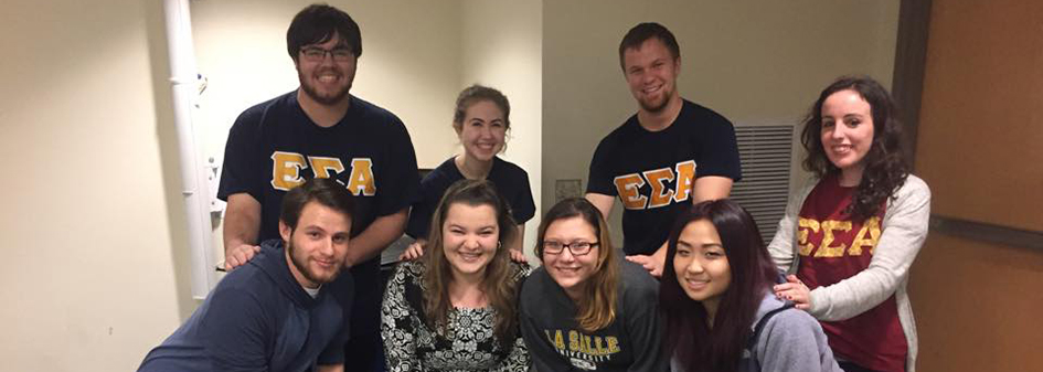 Collegiate ESA members from Florida State University pose with charters at a trip to an amusement park.