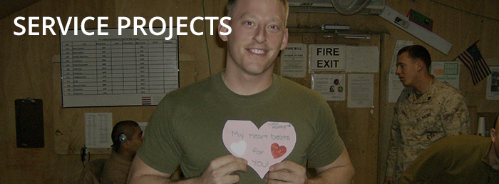 An active duty soldier holds a valentine sent from ESA members through the Hope For Heroes Program