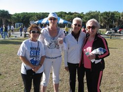 Alpha Nau members stand on the beach at the JDRF Walk for a Cure